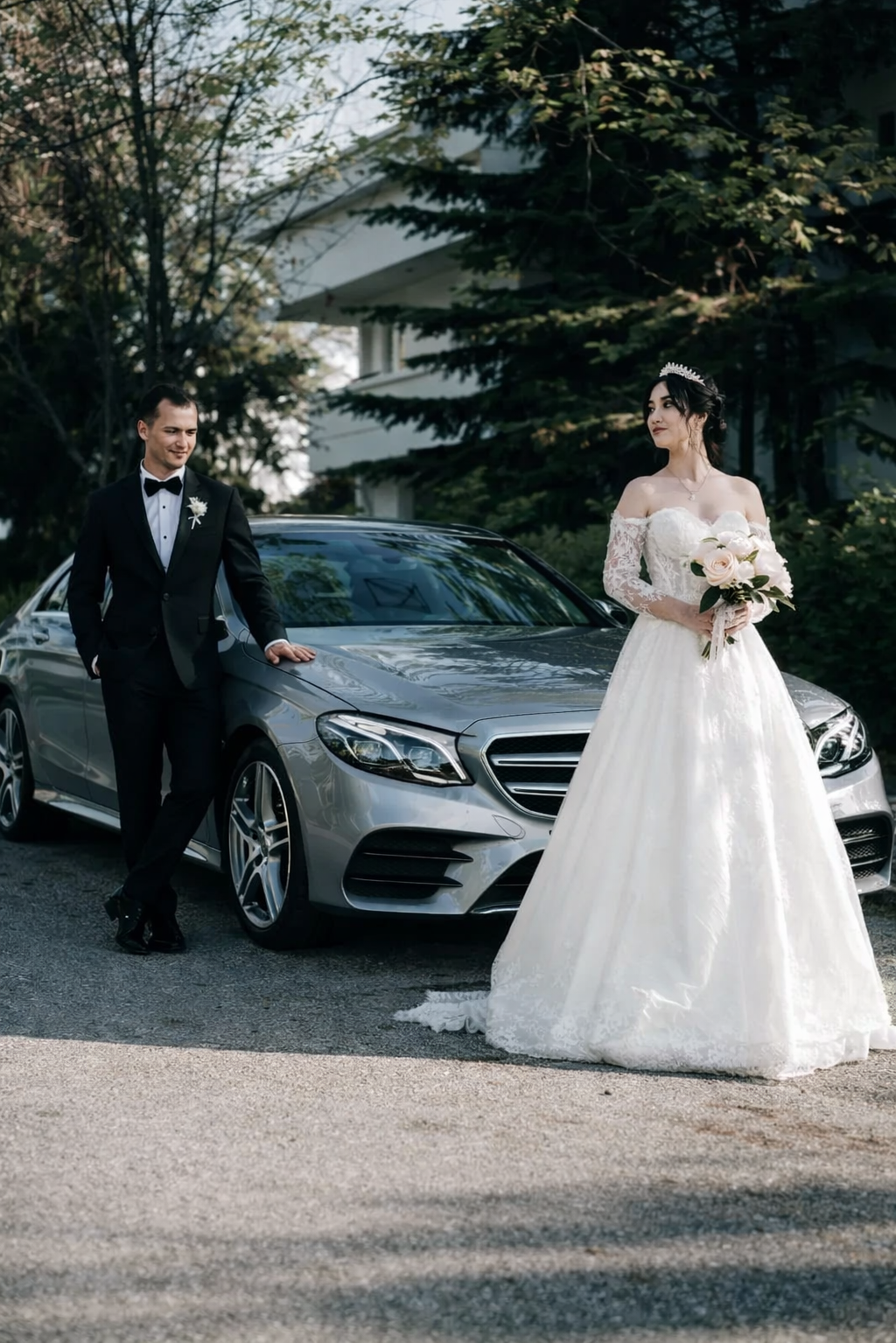 Bride and groom next to luxury car
